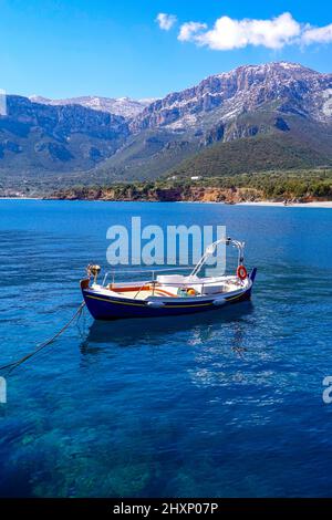 Kleines blaues Ruderboot im kleinen abgelegenen Dorf Kyparissi im Winter auf dem Peloponnes, Arcadia, Griechenland Stockfoto