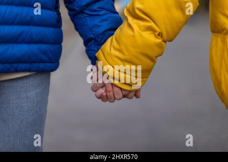 Nahaufnahme eines jungen Paares mit Händen, ukrainischem Krieg- und Friedenskonzept. Stockfoto