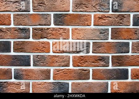 Hintergrund rote Mauerziegel mit Zement Nahaufnahme. Rote Backsteinwand Textur Dekoration Panel. Stockfoto