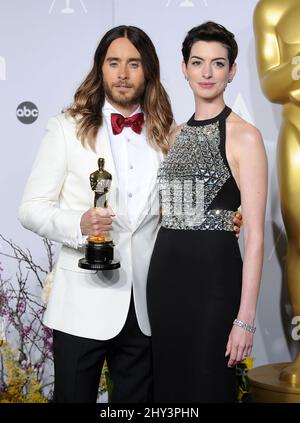 Jared Leto posiert im Presseraum mit seiner Auszeichnung als bester Nebendarsteller für seine Rolle im „Dallas Buyers Club“ mit Anne Hathaway während der Oscars im Dolby Theater am Sonntag, den 2. März 2014 in Los Angeles. Stockfoto