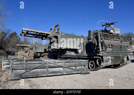 US-Soldaten, die der 41. Field Artillery Brigade zugewiesen wurden, laden M270 Multiple Launch Rocket Systems für eine Live-Feuerübung auf dem 7. Army Training Command's Grafenwoehr Training Area, Deutschland, 11. März 2022. Die Stationierung von US-Streitkräften ist hier eine umsichtige Maßnahme, die die kollektiven Ziele der NATO zur Kriegsprävention, die defensive Ausrichtung und das Engagement für den Schutz aller Verbündeten untermauert. (USA Armeefoto von Gertrud Zach) Stockfoto