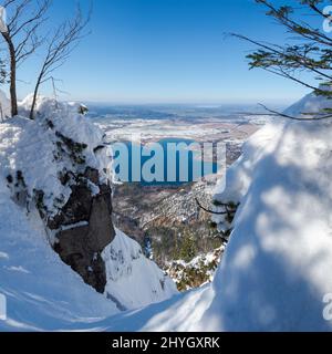 Blick auf den Kochelsee und die Ausläufer der Alpen bei München. Blick vom Mt. Jochberg am Walchensee im Winter in den bayerischen Alpen. Stockfoto