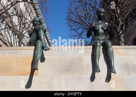 Bronzestatuen von Schwimmerinnen, die an einer Wand neben der Spree Mitte in Berlin sitzen Stockfoto