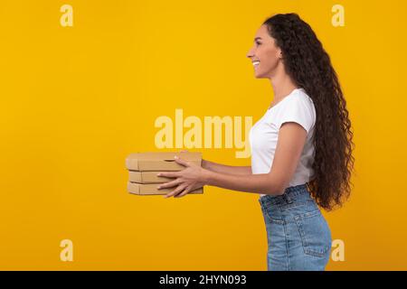 Happy Latin Lady Hält Pizzakisten Im Studio Stockfoto