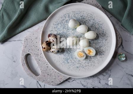Die gekochten Eier liegen auf dem Teller, auf dem Brett. Nützliche und leckere Zutat. Stockfoto