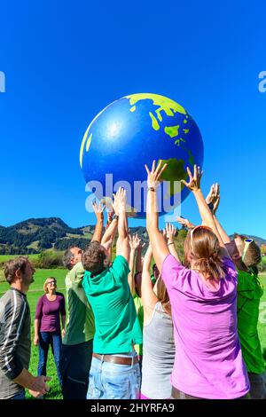 Tragen wir die Welt auf unseren Händen Stockfoto