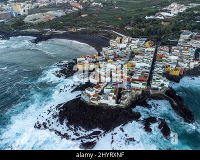 Luftaufnahme auf bunte Häuser und schwarze Lavasteine im kleinen Fischerdorf Punta Brava in der Nähe von Puerto de la Cruz, Teneriffa, Kanarische Inseln bei Sonnenaufgang Stockfoto