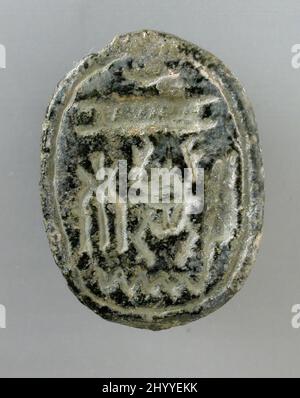 Scarab mit kryptografischer Schrift des Gottes Name Amen-Re. Ägypten, 19. - 20. Dynastie (1315 - 1081 v. Chr.) oder vielleicht später. Skulptur. Dunkelgrauer Steatit Stockfoto