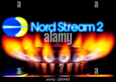 Gasbrenner auf dem Hintergrund des Nord Stream 2 Logos Stockfoto