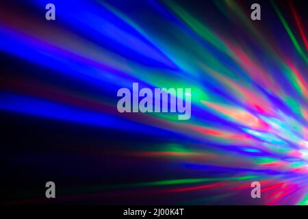 Bunte Lichtstrahlen oder Lichtstrahlen bei Dunkelheit. Abstrakter, hochauflösender Hintergrund. Stockfoto