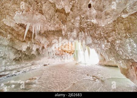 Schöne reine und klare Eiszapfen, die die Decke der Eishöhle am See bedecken Stockfoto