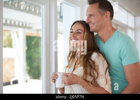 Den Tag beginnen. Ein kurzer Schuss eines glücklich verheirateten Paares, das am Morgen Kaffee trinkt. Stockfoto