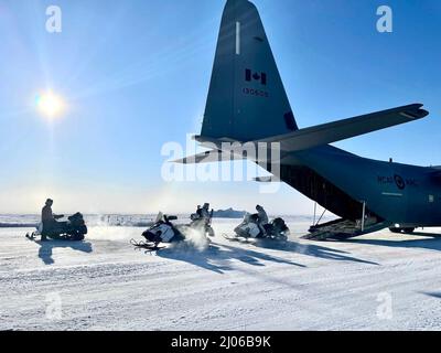 Green Berets mit 10. Special Forces Group (Airborne) laden Schneemobile auf eine Royal Canadian Air Force C-130 Hercules während der Übung ARCTIC EDGE 2022 in Wainwright, Alaska, 12. März 2022. AE22 ist eine binationale Übung, die alle zwei Jahre stattfindet und die Teilnehmer an den wichtigsten Schulungsorten in ganz Alaska, vom 28. Februar bis zum 17. März, realistisch und effektiv ausbildet. (DoD-Foto) Stockfoto