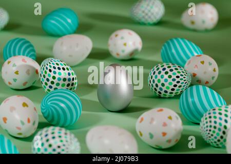 Farbige Ostereier um Silberei auf grünem Hintergrund. 3D Rendern Stockfoto