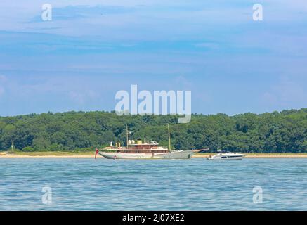 Yachten in Smith Cove an einem Sommertag mit Shelter Island im Hintergrund Stockfoto