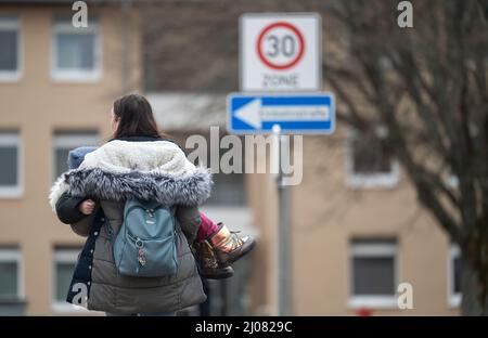 17. März 2022, Baden-Württemberg, Meßstetten: Eine Frau, die aus Achtyrka in der Ukraine geflohen ist, trägt ihr Kind in den Armen in der ehemaligen Zollernalb-Kaserne. In den letzten Tagen wurde in der ehemaligen staatlichen Erstaufnahmeeinrichtung im Bezirk Zollernalb ein Ankunftszentrum für Flüchtlinge aus der Ukraine eingerichtet., Foto: Marijan Murat/dpa Stockfoto