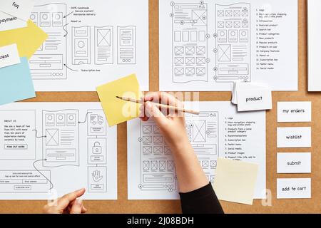 Web UX Designer arbeitet an mobilen responsive Website-Projekt. Flachbild von zahlreichen Web-Wireframe-Skizzen und Kartensortiertechnik über PR Stockfoto