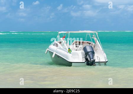 Schnellboot an einem wunderschönen Strand ohne Leute. Touristisches Schnellboot am Barra Grande Strand, Maragogi - AL, Brasilien. Bootstour Konzept auf dem touristischen Zentrum Stockfoto