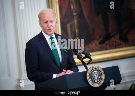 Washington, USA. 17. März 2022. US-Präsident Joe Biden spricht während einer Veranstaltung zum St. Patrick's Day im Ostsaal des Weißen Hauses in Washington, DC, USA, am Donnerstag, den 17. März, 2022. Biden lobte Irland für die Aufnahme ukrainischer Flüchtlinge während eines Treffens mit dem irischen Premierminister Micheal Martin am Donnerstag, das schnell virtualisiert wurde, nachdem der Premier positiv auf Covid-19 getestet wurde. Fotograf: Al Drago/Pool/Sipa USA Kredit: SIPA USA/Alamy Live News Stockfoto