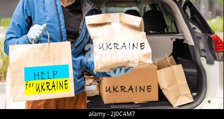 Sammeln eines humanitären Nahrungsmittelset, um Menschen zu helfen, die während des Krieges durch Russland gelitten haben, beenden Sie den Krieg in der Ukraine, humanitäre Hilfe 2022 Stockfoto