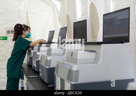 Harbin, Chinas Provinz Heilongjiang. 18. März 2022. Ein medizinischer Mitarbeiter testet Geräte in einem mobilen Testlabor für COVID-19 in Harbin, nordöstlich der Provinz Heilongjiang, 18. März 2022. Quelle: Xie Jianfei/Xinhua/Alamy Live News Stockfoto