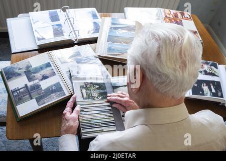 Blick von oben auf ein älterer Mann in alten Fotoalben Stockfoto