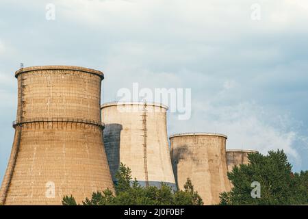 Die Fabrik gibt Rauch aus Rohren, die die Atmosphäre verschmutzen, in den Himmel Stockfoto