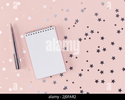 Stift und Notizbuch mit verstreuten Sternen und Kreisen auf einem zarten rosa Hintergrund. 3D-Rendering Stockfoto