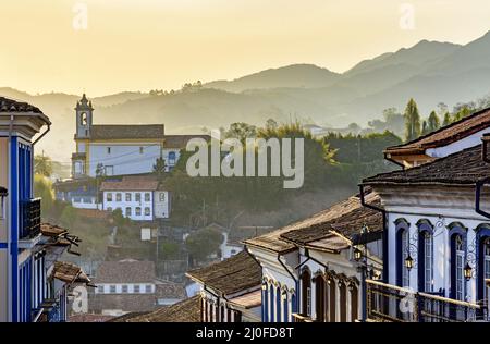 Fassaden von Häusern und Kirche in Kolonialarchitektur in einer alten Straße in der Stadt Ouro Preto Stockfoto