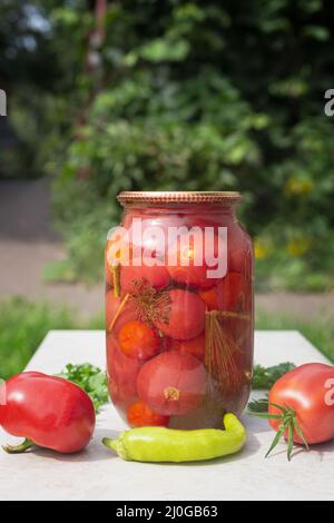Tomaten aus der Dose in einem großen Glas. Stockfoto