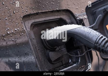 Elektroauto mit Ladestation verbunden - Nahaufnahme Stockfoto