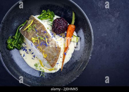 Modernes, traditionelles, gebratenes Kabeljaufischfilet mit Baby-Brokkoli Stockfoto