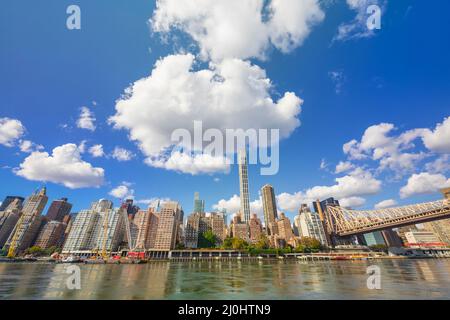 Am 2021. November schweben von Roosevelt Island aus große Wolken über dem Wolkenkratzer von Midtown Manhattan jenseits des East River. Stockfoto