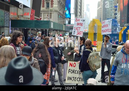 Während der World Freedom Rally am Times Square in New York City am 19. März 2022 wird ein Teilnehmer mit einem Anti-Covid-19-Impfbanner gesehen. Stockfoto