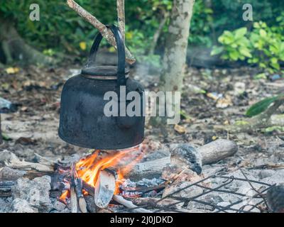 Kochen am Lagerfeuer auf einer kleinen Wüsteninsel, Venu Island, Pulau Venu, in der Nähe von Kaimana, West Papua, Indonesien Stockfoto