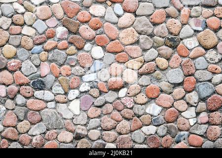 Hintergrund von einer Wand aus Kieselsteinen Stockfoto