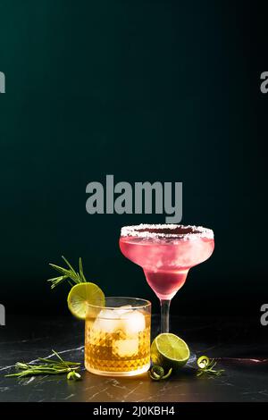 Alkoholische und alkoholfreie Cocktails auf einem dunklen Marmortisch. Erfrischungen im Sommer Stockfoto