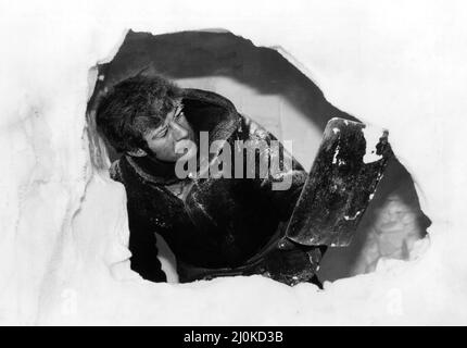Sir Ranulph Twistleton Wykeham Fiennes, Forscher, am Nordpol während der Transglobo Expedition. Sir Ranulph schnitzt eine Höhle im Eis aus, um vorübergehend Schutz zu erhalten. 11.. April 1982. Stockfoto