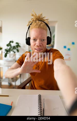 Albino-afroamerikanischer Mann, der von zu Hause aus arbeitet und Videoanruf macht Stockfoto