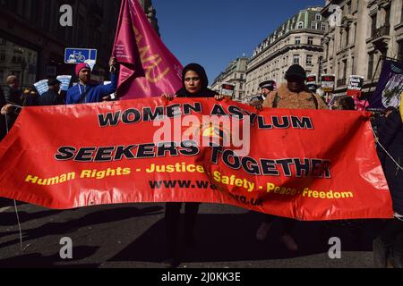 London, England, Großbritannien. 19. März 2022. Demonstranten halten ein Banner zur Unterstützung von Asylbewerberinnen in der Regent Street. Demonstranten marschierten durch Central London, um gegen Rassismus und Flüchtlinge zu protestieren. (Bild: © Vuk Valcic/ZUMA Press Wire) Stockfoto