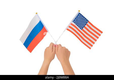 Weibliche Hand mit russischen und amerikanischen Flaggen, isoliert auf weißem Hintergrund Stockfoto