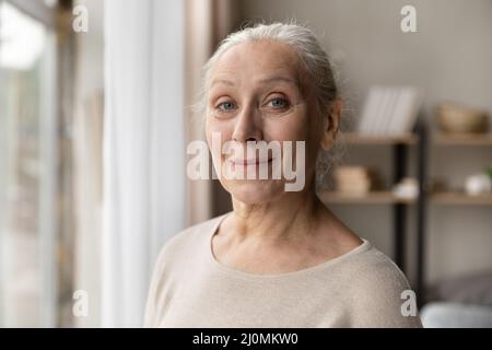 Kopfschuss Porträt Attraktive ältere Frau posiert innen Stockfoto