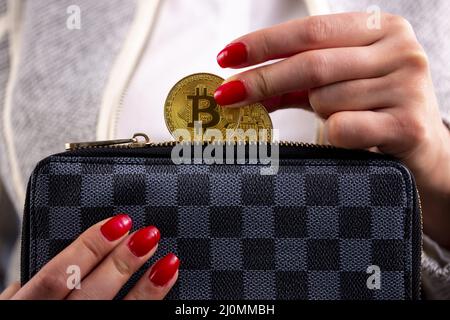 Bitcoin Münzen in der Handtasche der Frau Stockfoto