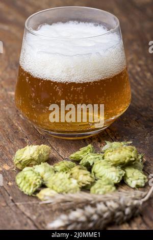 Indian Pale Ale mit Hopfen auf Holz Stockfoto