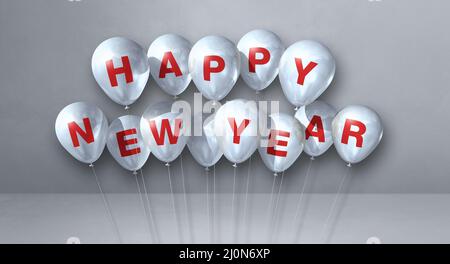 Weiße, fröhliche Neujahr-Ballons auf grauem Betongrund. Horizontales Banner Stockfoto
