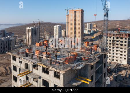 Wladiwostok, Russland - 2. März 2022: Bau eines neuen Hauses. Draufsicht auf den Bau des oberen Stockwerks. Stockfoto