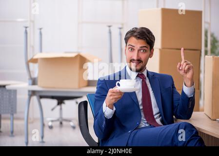 Junger männlicher Mitarbeiter im Umzugskonzept Stockfoto