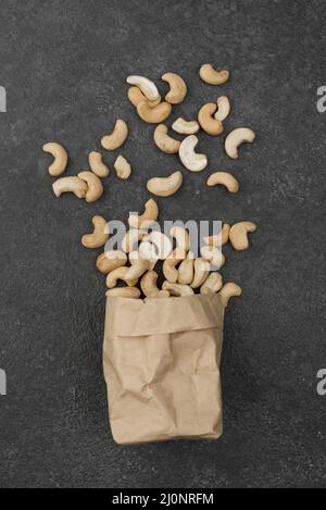 Papiertüte gefüllt mit gesunden rohen Cashewnüssen. Hohe Qualität und Auflösung schönes Fotokonzept Stockfoto
