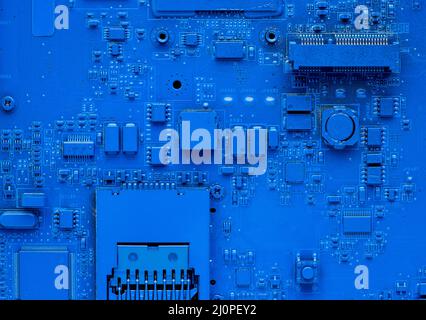 Hauptplatine des Computers. Klassischer blauer Hintergrund mit pc-Hintergrund, Nahaufnahme. Einfarbiger Mikrochip Stockfoto