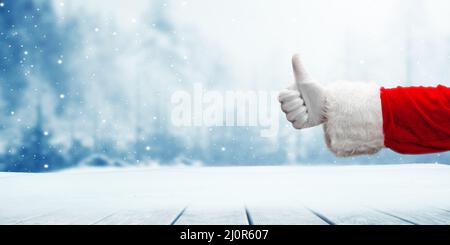 Die Hand des Weihnachtsmanns zeigt die Daumen nach oben. Stockfoto